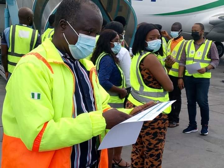 NEMA, NCFRMI, and IOM officials attending to repatriated Nigerians