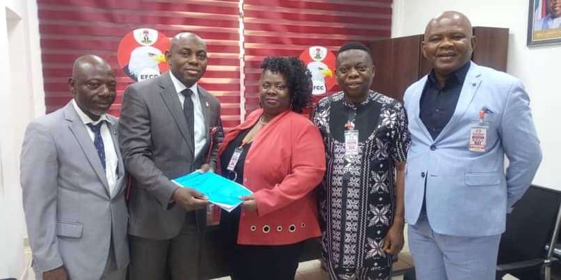 Cheryldene Cook receiving documents from EFCC officials