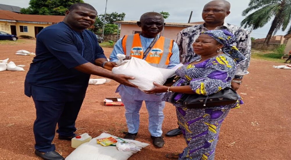 LEMC coordinator, Mr Oko, (middle) and council chairman, Barr Nkwuo, (l) giving a bag of rice to a beneficiary